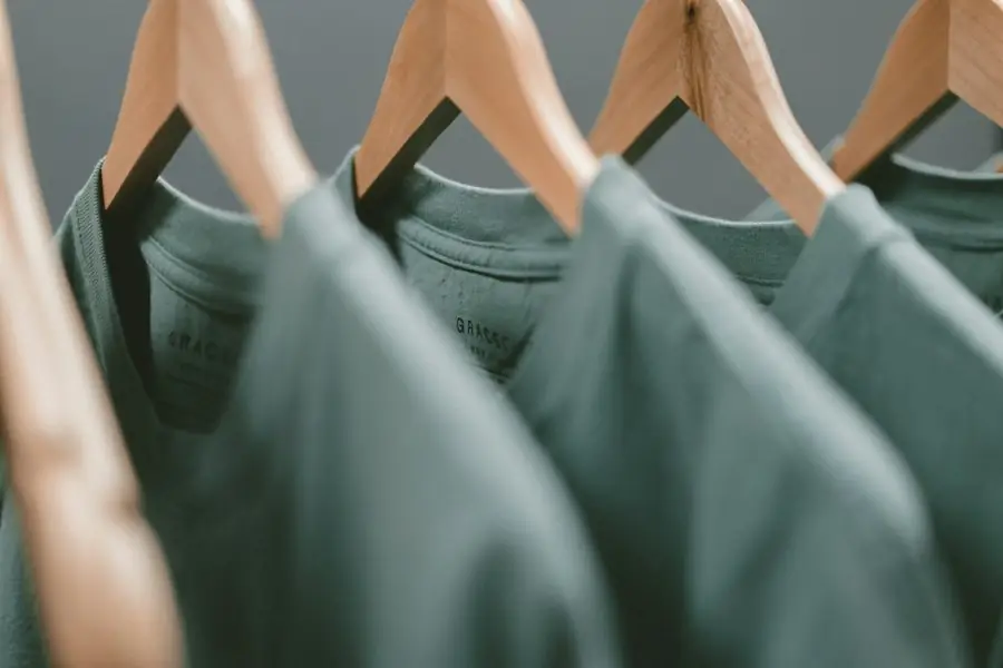 T-shirts on wooden hangers